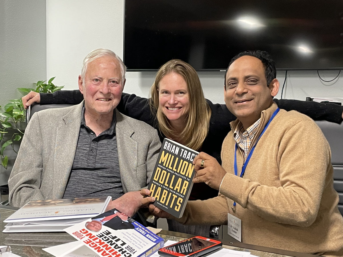 Dr Ash Kumar with Brian Tracy, bestselling author of Eat That Frog, holding Brian's book Million Dollar Habits