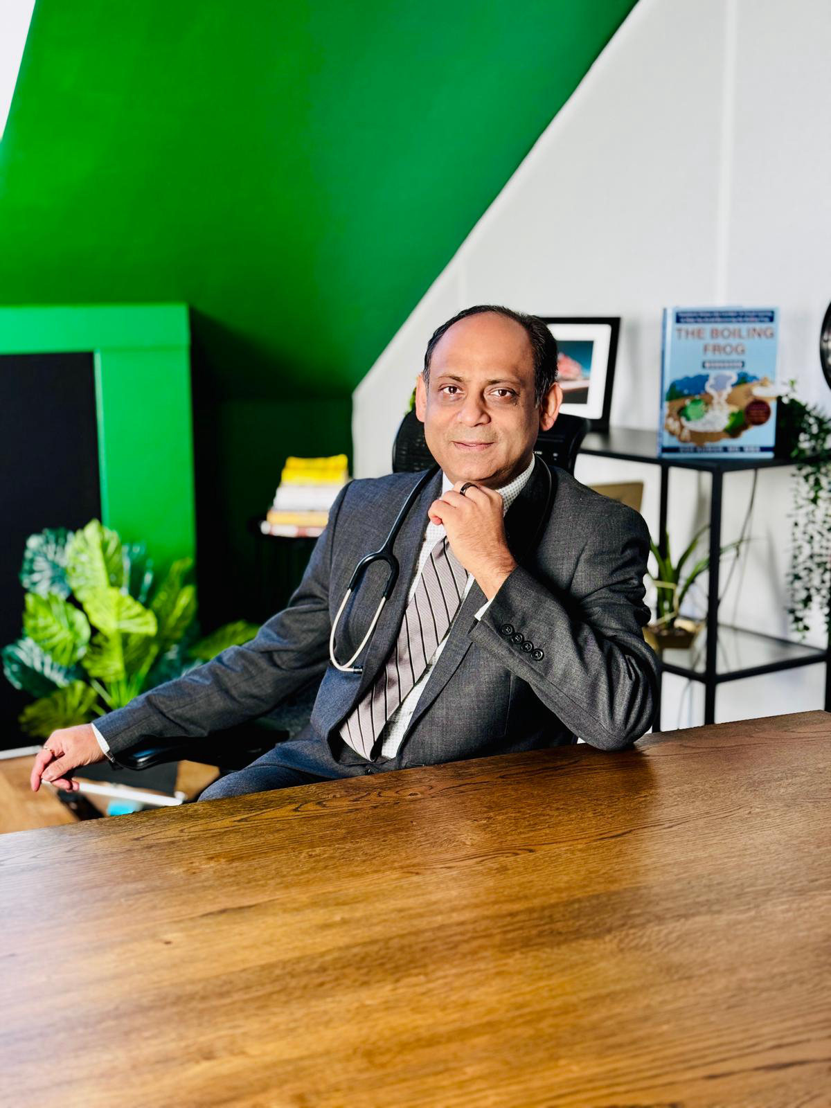 Dr Ash Kumar, Consultant Physician and author of The Boiling Frog, at his desk
